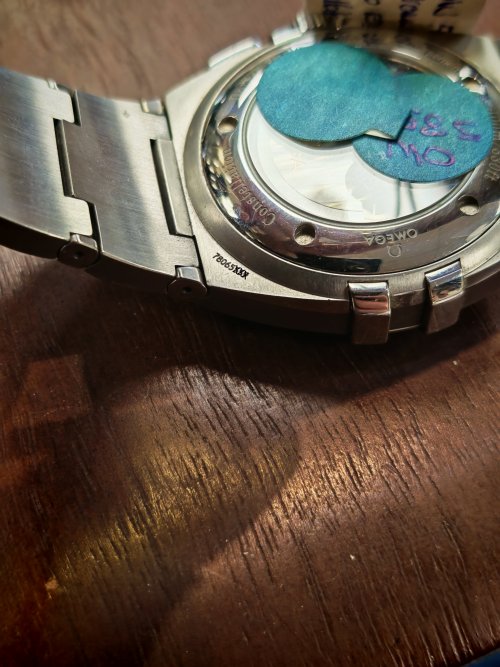 location of serial number and caliber number on an omega watch case lug